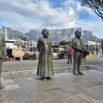 A group of statues of men standing next to each other
