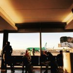 a group of people standing in front of a window