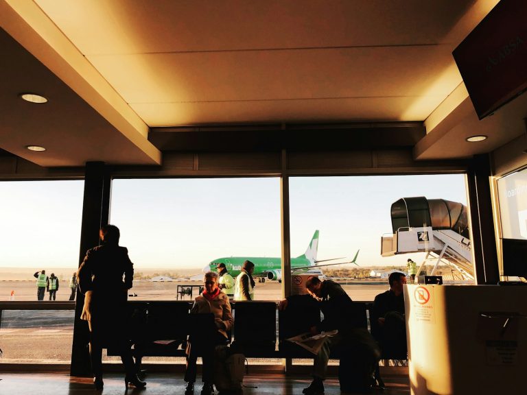 a group of people standing in front of a window