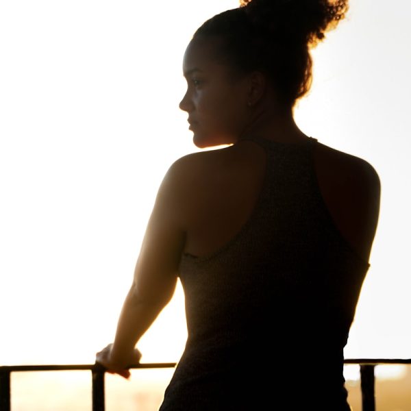 woman in black tank top standing near railings