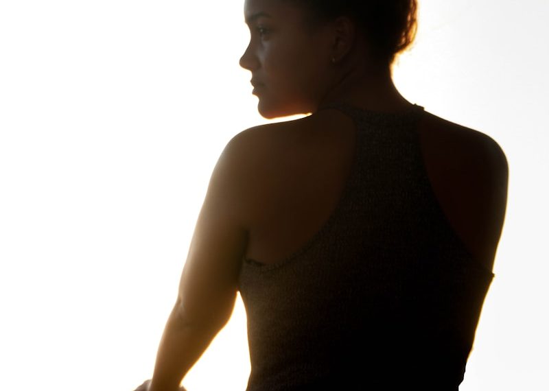 woman in black tank top standing near railings