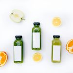 3 bottles with sliced lemon and sliced orange fruits