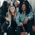 3 women sitting on red carpet