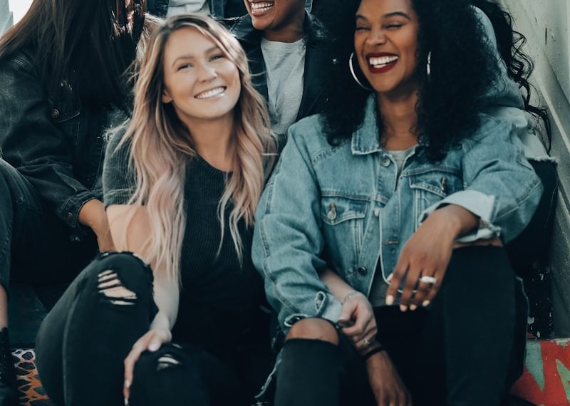 3 women sitting on red carpet