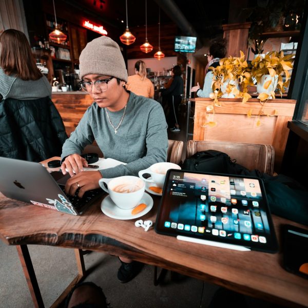 a man sitting at a table working on a laptop