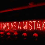 a neon sign that says itbegan as a mistake