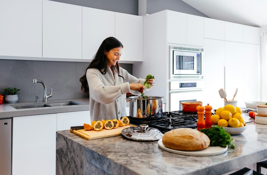 woman smiling while cooking