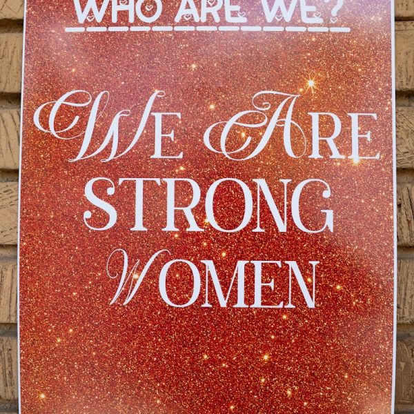 Poster reads 'who are we? we are strong women'.